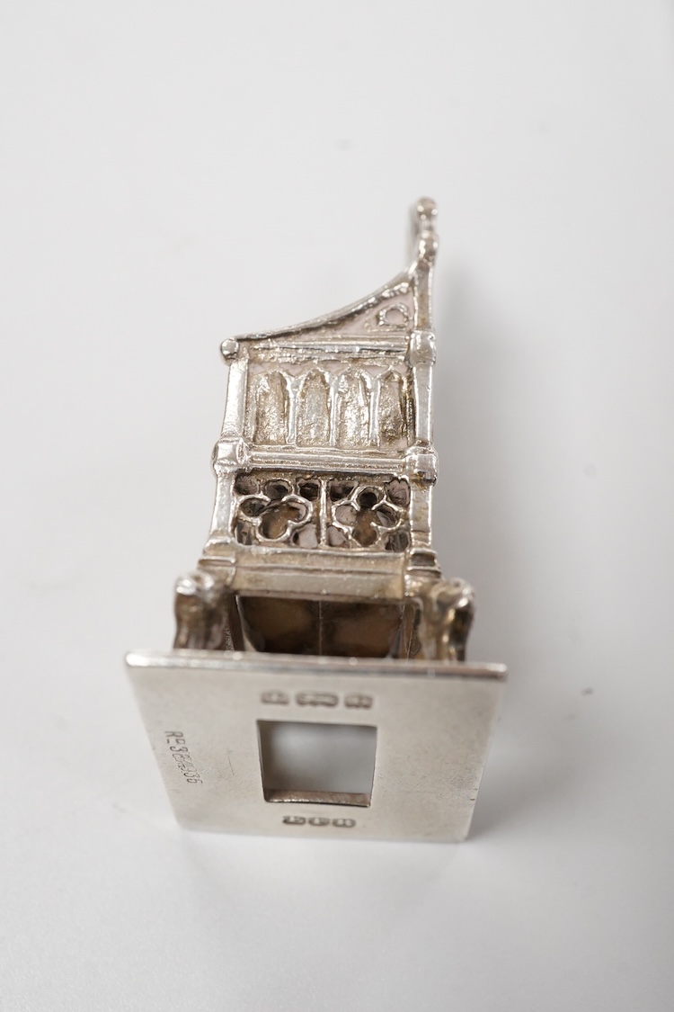 A small group of silver including an Edwardian miniature model of a throne by Edward Foligne Braham, Birmingham, 1901, 50mm, a small comport, one part of a belt buckle and three commemorative spoons, together with a gilt